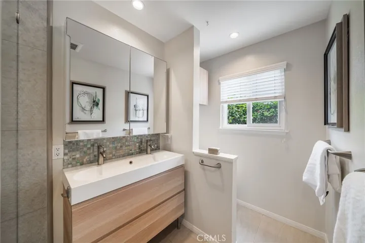 Primary bath has window that opens to outside.