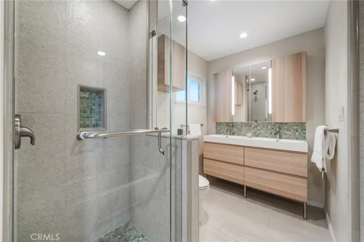 The secondary bath also has a step-in shower and nook for products.