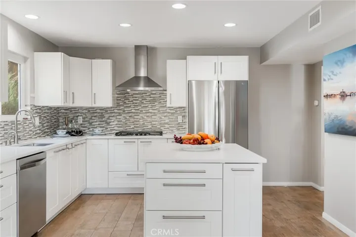 There is space to right of refrigerator to build in shelves or a rack to create more storage space.