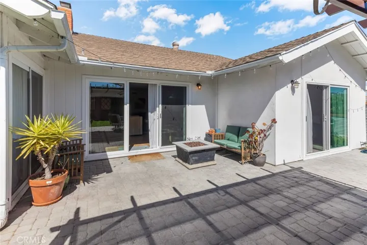 Back of the home showing the 3 exits to back yard. On left is from the Family room, the middle is the Living room and the right is the Primary Bedroom. Please note none of the planters or furniture are at home now.