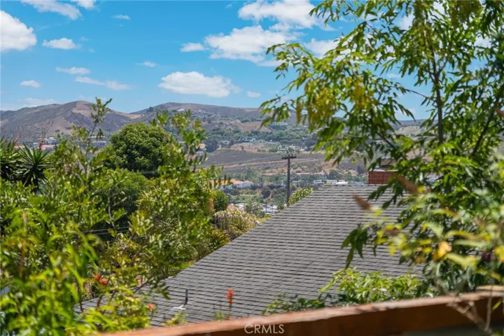 Taken up against the fence notice the home is lower as these are on terraced lots. Sunrise in San Juan Capistrano comes up over the hills.