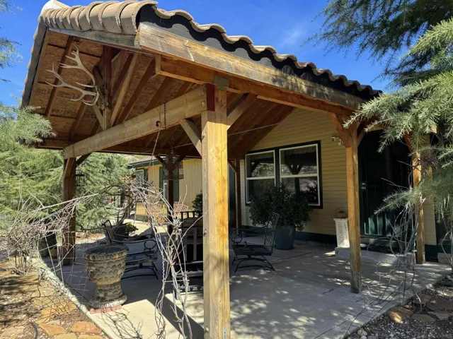 The home sits high on the land and has added shade structure to help keep the home cool in the summer