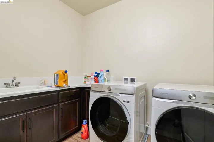 Laundry area with separate washer and dryer and cabinet space