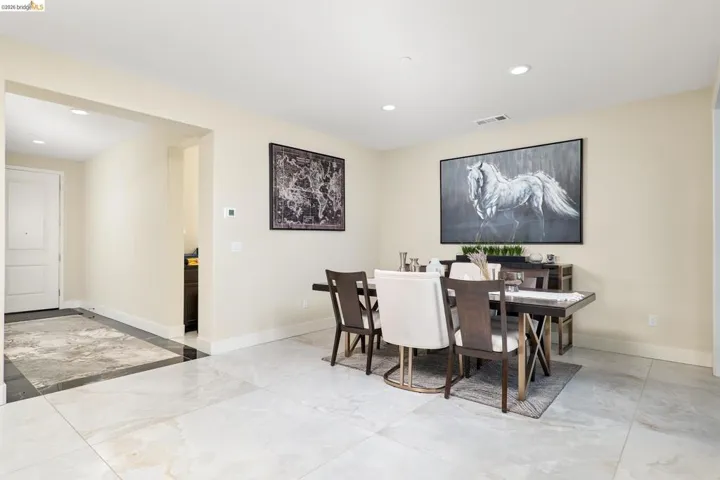 Dining area with recessed lighting and light marble finish flooring