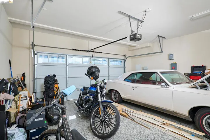 Garage featuring electric panel and a garage door opener
