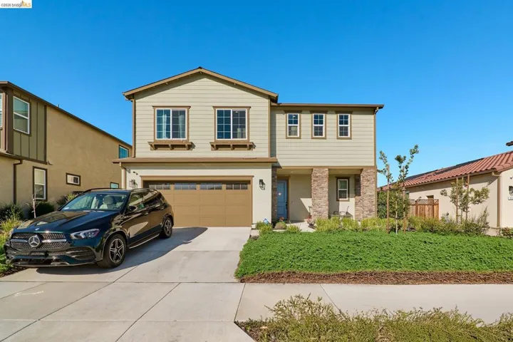 Traditional home featuring concrete driveway and an attached garage