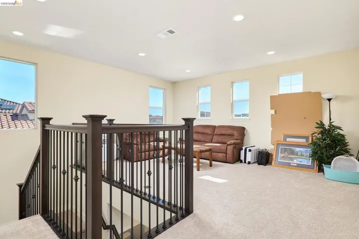 Corridor featuring recessed lighting, carpet flooring, healthy amount of natural light, and an upstairs landing