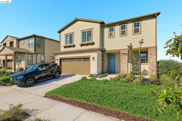 View of front facade featuring an attached garage and driveway