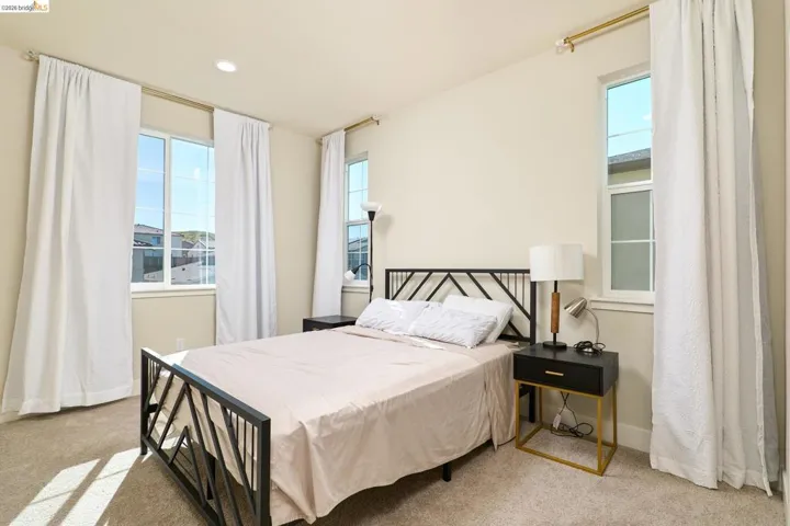 Bedroom with light carpet and recessed lighting