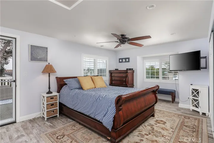 Primary bedroom with door leading to garage roof sundeck.