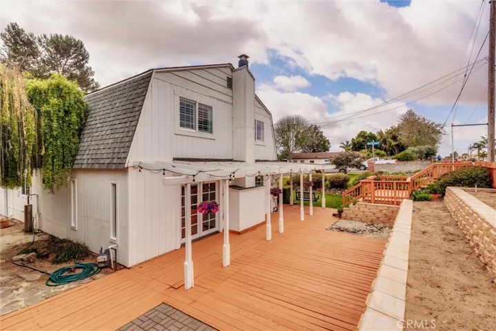 Side yard view with garden beds.