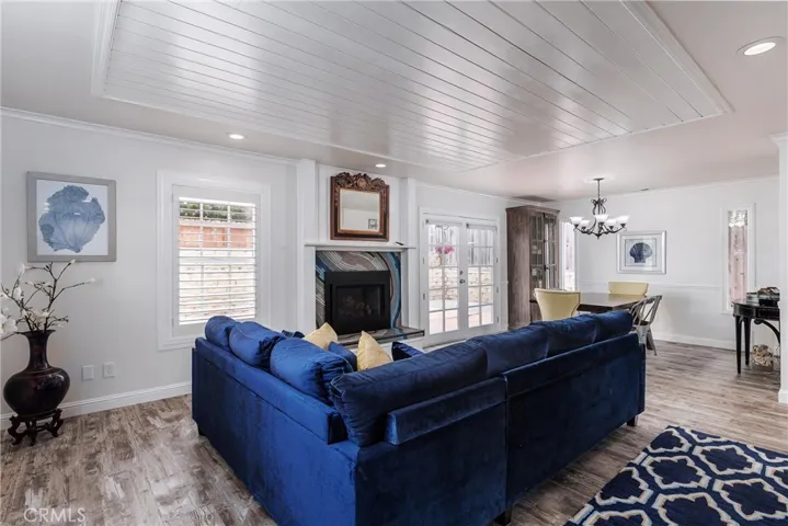 Living room with fireplace and dining room.