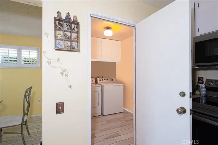 Laundry Room with wood like tile floors.