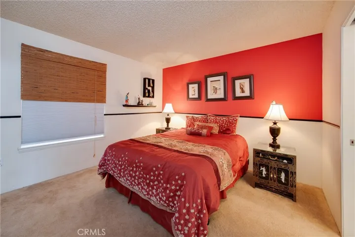 The guest bedroom has wainscoting , mirrored closet doors and direct access to a full bath.