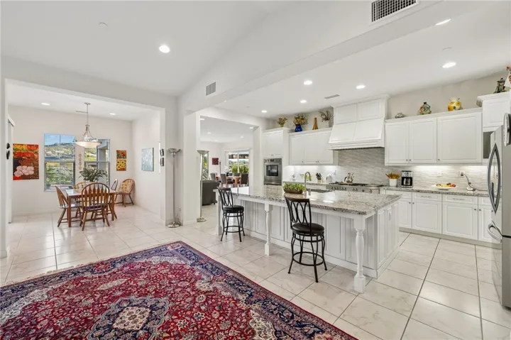 Open-concept kitchen flows seamlessly into the dining space, creating an inviting layout for everyday living and casual entertaining.