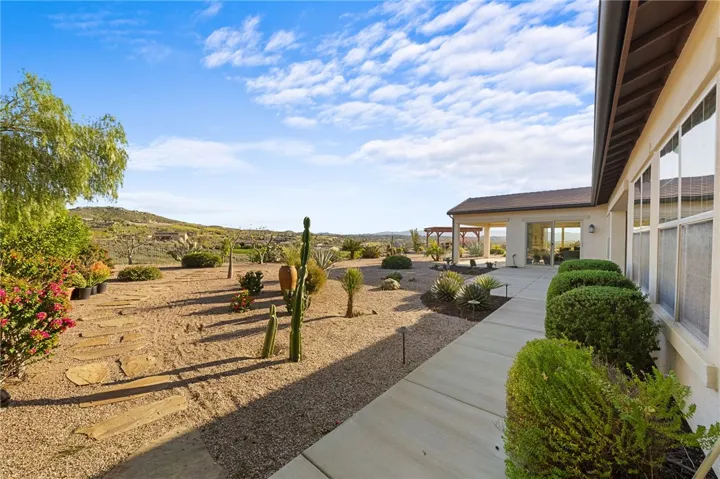 Large covered patio provides a shaded outdoor living area with plenty of room for relaxing and entertaining.