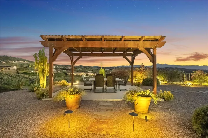 Covered pergola patio offers a peaceful setting for outdoor dining and entertaining with open views across the landscape.