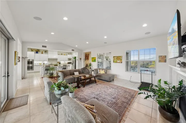 Spacious great room connects effortlessly to the kitchen, creating a light-filled central gathering space with an open, airy feel.