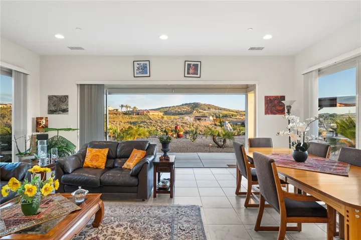 Large sliding glass doors frame the backyard setting and create a seamless connection between the dining area and covered patio.