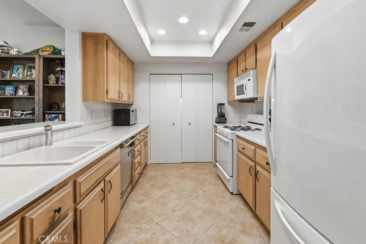 Huge kitchen with loads of cabinets and counters