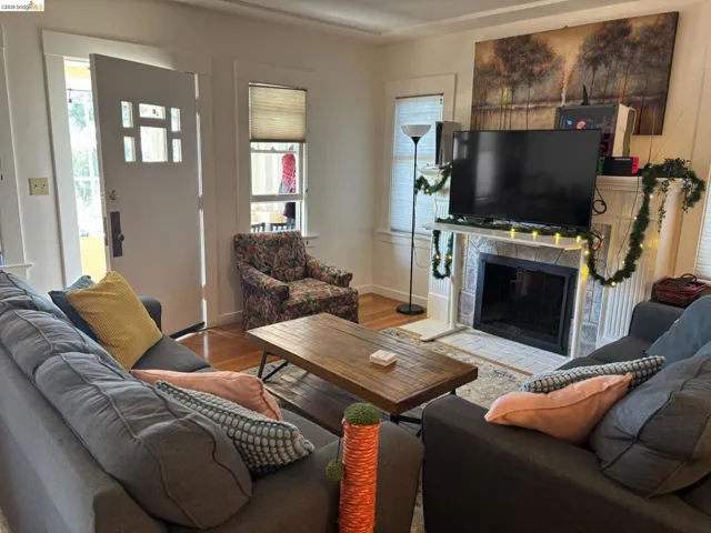 Living room featuring a high end fireplace and wood finished floors