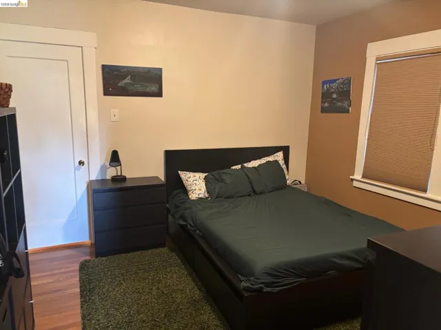 Bedroom featuring dark wood-type flooring