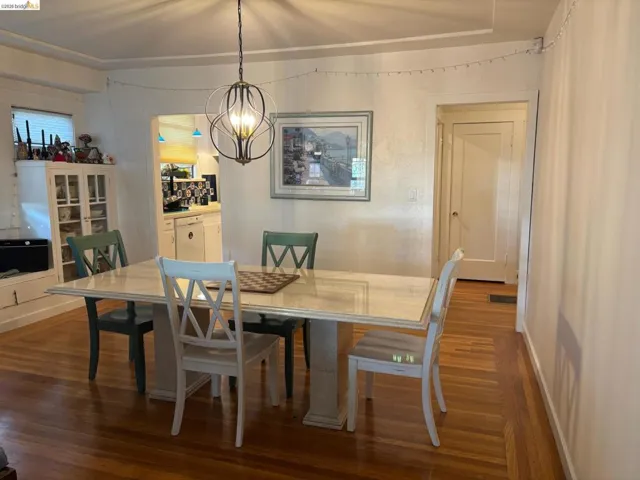 Dining room featuring dark wood finished floors and hanging lights