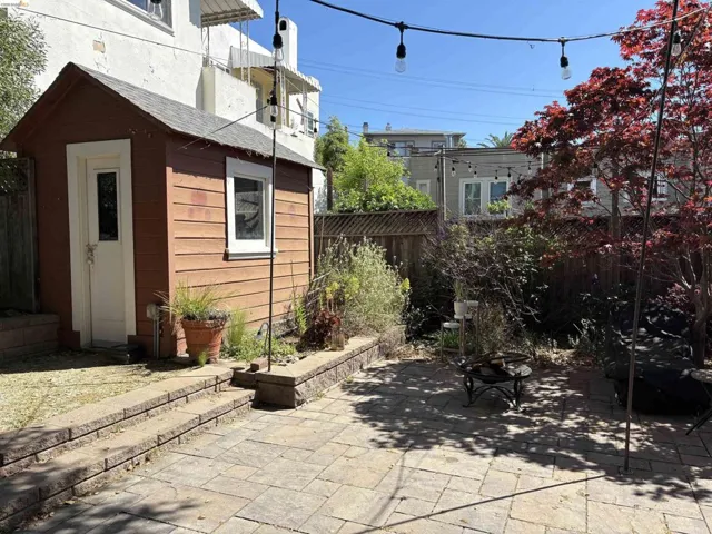 Fenced backyard with a patio area and an outdoor structure