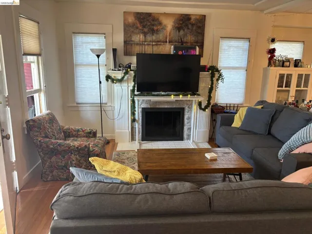 Living area featuring wood finished floors and a fireplace