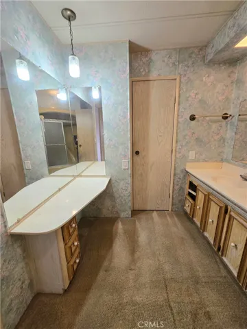 Primary bathroom with double sinks, tub and extra closet.