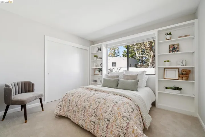 Bedroom with a closet and light colored carpet