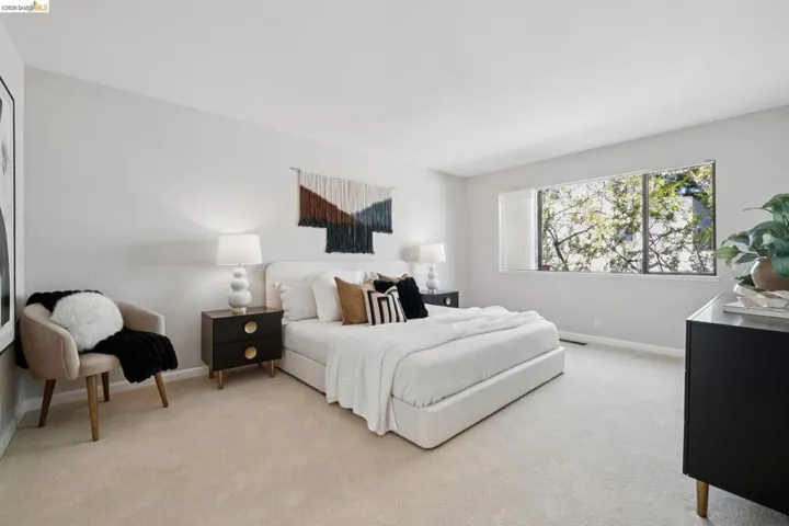 Bedroom featuring light colored carpet and baseboards