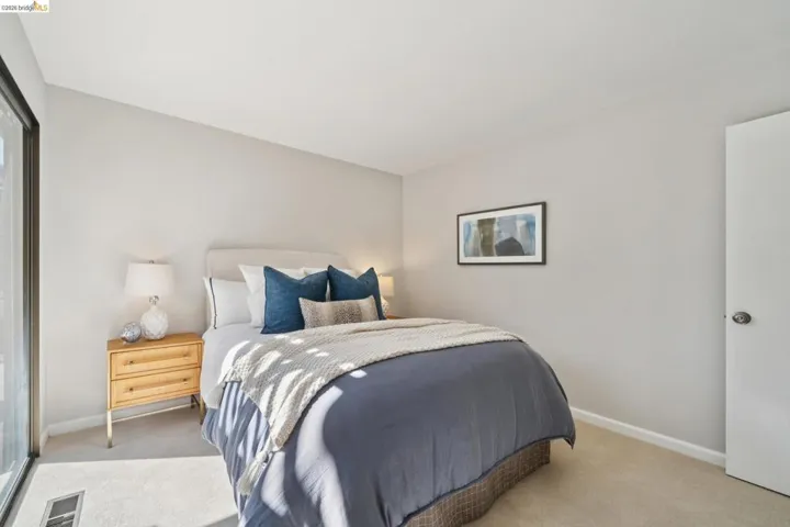 Bedroom with light carpet and baseboards