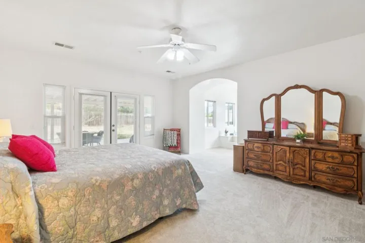This primary suite is the ultimate, spacious, French doors towards the back patio, its own private tub, double sinks, large walking shower, and walking closet. This is home with large bedrooms in Ramona