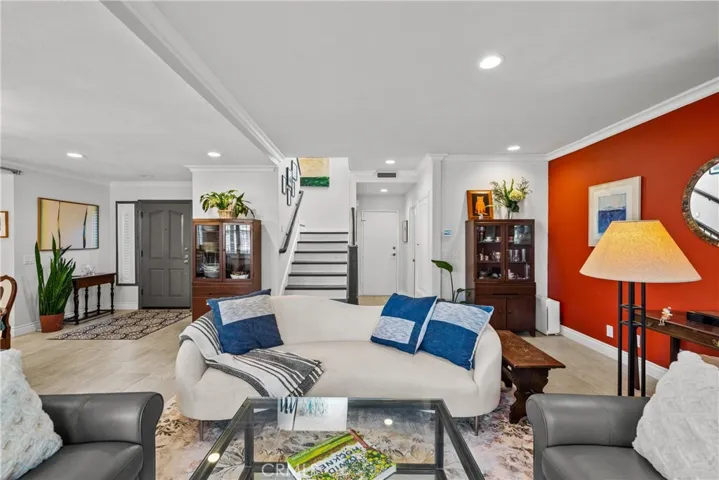 View of living room, entry room, hallway bath to garage and stairwall from the sliding door to outside on main level.