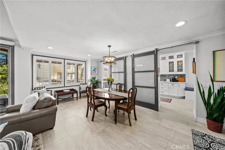 View of dining space that opens up to kitchen from middle of room. Notice sitting space by window (larger than it looks perfect for a mini-bar)