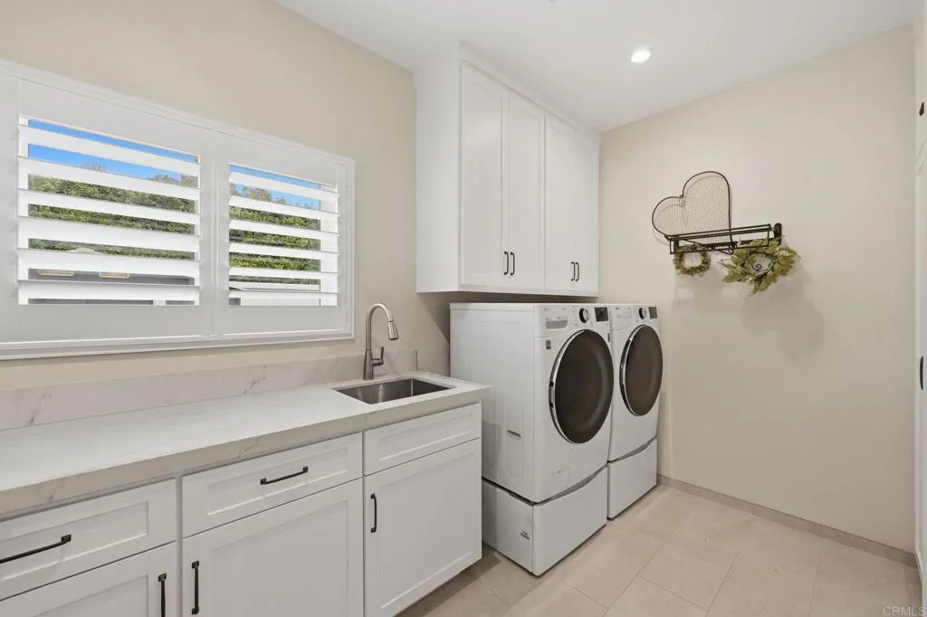 Laundry Room with sink, countertop for folding and extra cabinets for storage.