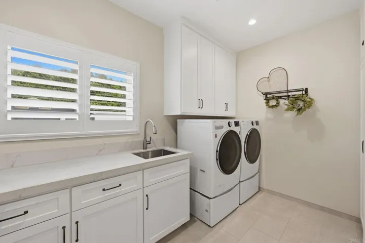 Laundry Room with sink, countertop for folding and extra cabinets for storage.
