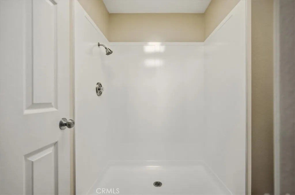 Re glazed walk in primary shower with new fixtures.
