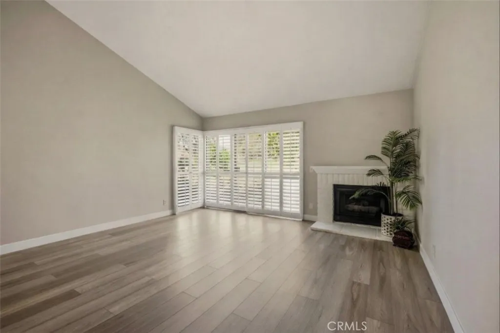 Slump stone firepace and plantation shutters.