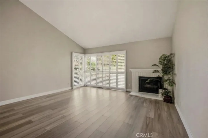 Slump stone firepace and plantation shutters.