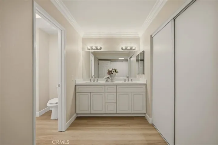 Completely remodeled primary vanity area with two closets.