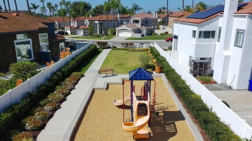 The play structure and green belt is directly across the street from the house.