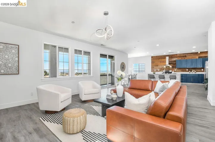 Living room with recessed lighting and light wood-type flooring