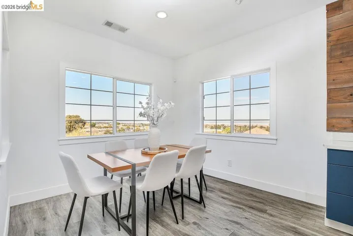 Dining room with light wood-style floors, plenty of natural light, and recessed lighting