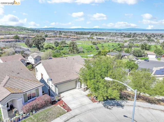 Aerial perspective of suburban area featuring a mountainous background