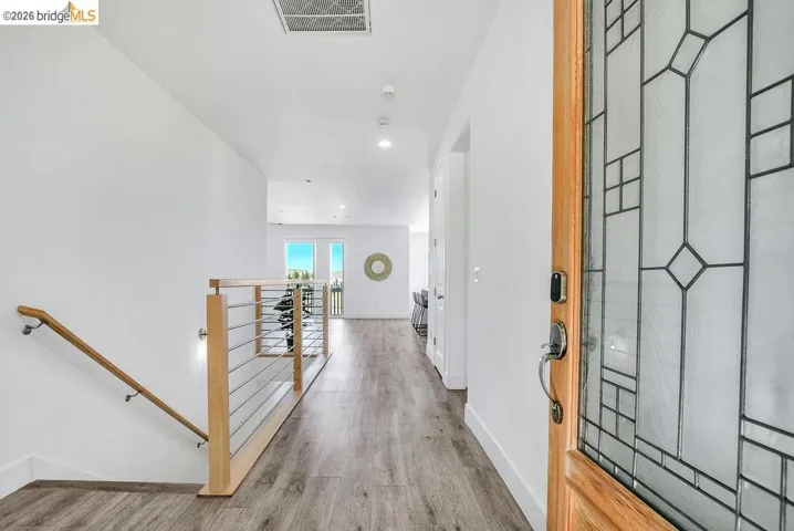 Entrance foyer with light wood-type flooring and recessed lighting