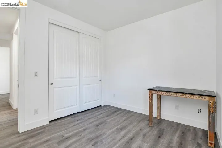 Unfurnished bedroom featuring wood finished floors and a closet