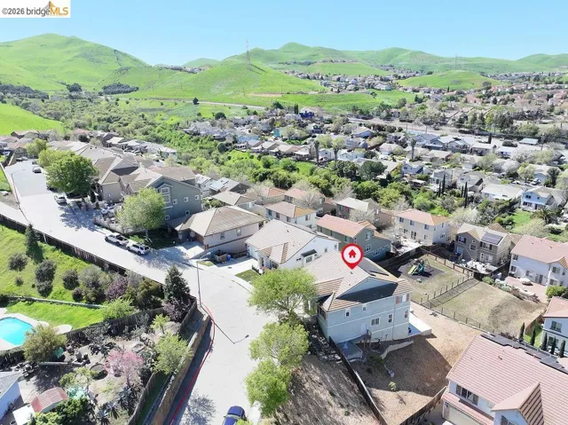 Aerial perspective of suburban area featuring a mountain backdrop