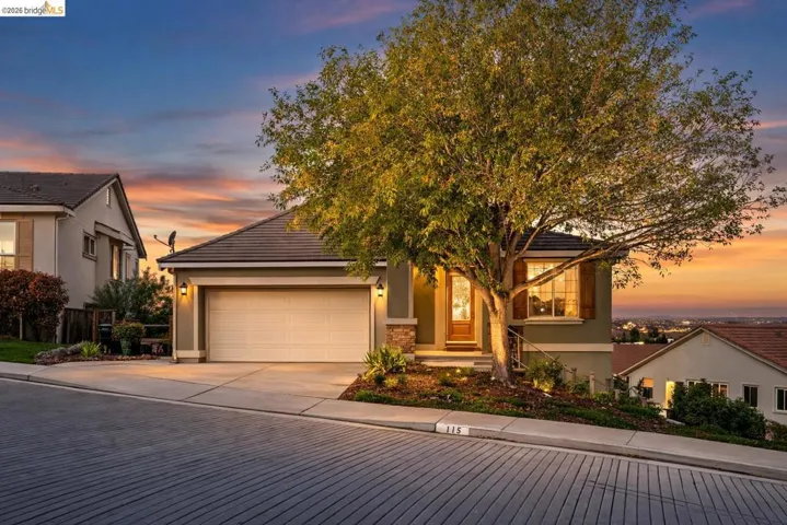 View of front of home with stucco siding, concrete driveway, and a​​‌​​​​‌​​‌‌​​‌​​​‌‌​​​‌​​‌‌​​‌‌​​‌‌​​​​ garage